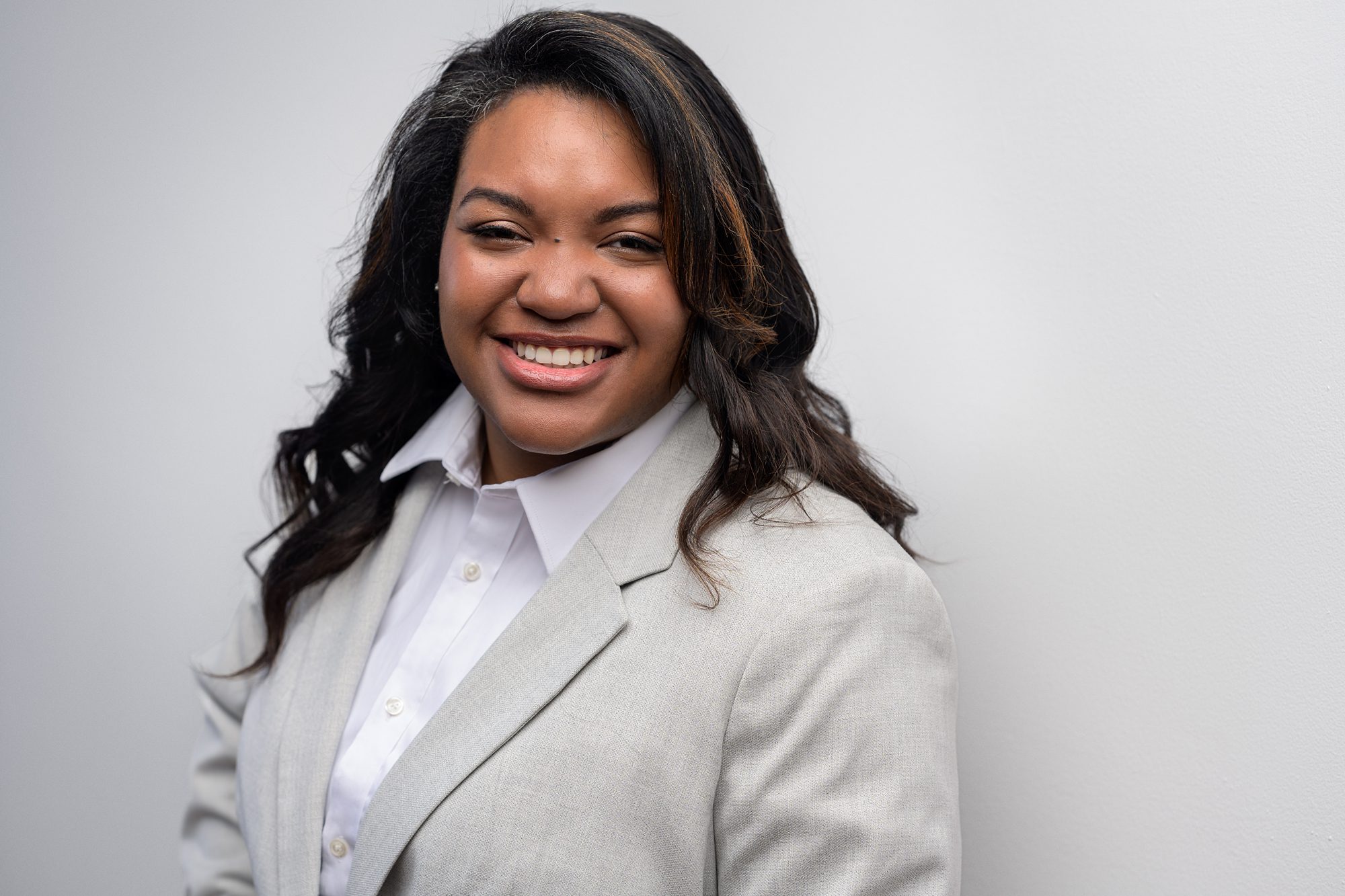 African American business woman headshot, photographed on a white background at the Faces You Love Photography Overland Park studio.
